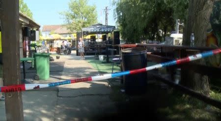 A police tape is seen in a cordoned area at a cafe after a shooting during a local festival in the village of Zitiste, north of Belgrade, Serbia in this still image from video taken July 2, 2016. Courtesy of N1 via REUTERS TV