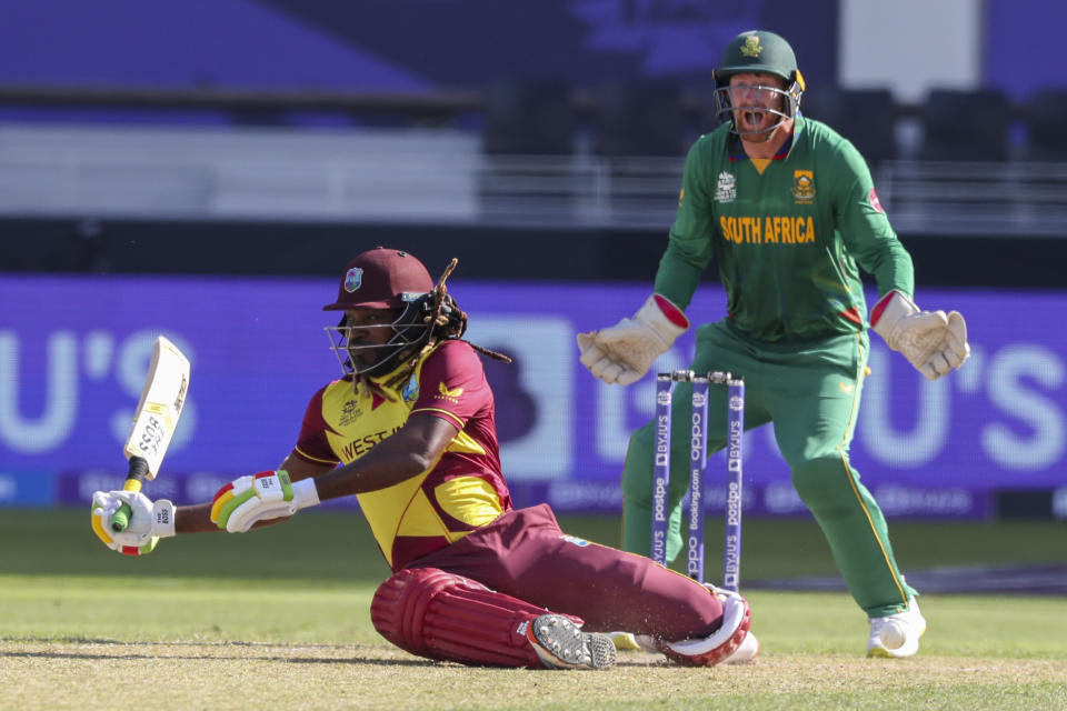 West Indies' Chris Gayle falls as he swings at the ball during the Cricket Twenty20 World Cup match between South Africa and the West Indies in Dubai, UAE, Tuesday, Oct. 26, 2021. (AP Photo/Kamran Jebreili)
