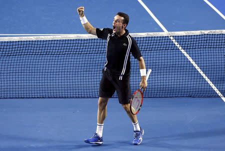 Spain's Roberto Bautista Agut celebrates after winning his third round match against Croatia's Marin Cilic at the Australian Open tennis tournament at Melbourne Park, Australia, January 22, 2016. REUTERS/Jason O'Brien