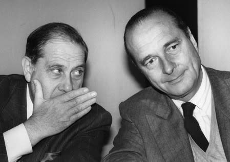 FILE PHOTO: French Interior Minister Charles Pasqua speaks to French Prime Minister Jacques Chirac during the last day of the Mayors of France Congress in Paris
