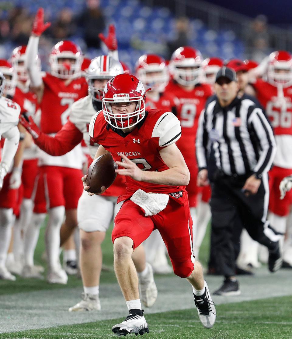 QB Owen McHugh runs down the sideline for a first down and more. Milton suffers its first loss of the season to Wakefield, 34-28, in the MIAA state championship at Gillette Stadium on Saturday, Dec. 3, 2022.