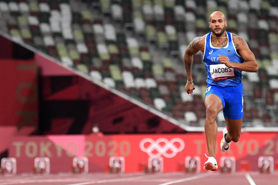 in Italy's Lamont Marcell Jacobs competes to first place in  the men's 100m final during the Tokyo 2020 Olympic Games at the Olympic Stadium in Tokyo on August 1, 2021. (Photo by Jewel SAMAD / AFP) (Photo by JEWEL SAMAD/AFP via Getty Images)