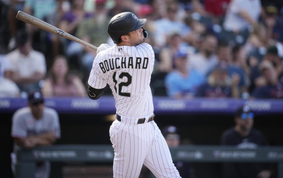 Colorado Rockies pinch-hitter Sean Bouchard follows the flight of his solo home run off Minnesota Twins relief pitcher Jorge Alcala in the eighth inning of a baseball game, Sunday, Oct. 1, 2023, in Denver. (AP Photo/David Zalubowski)