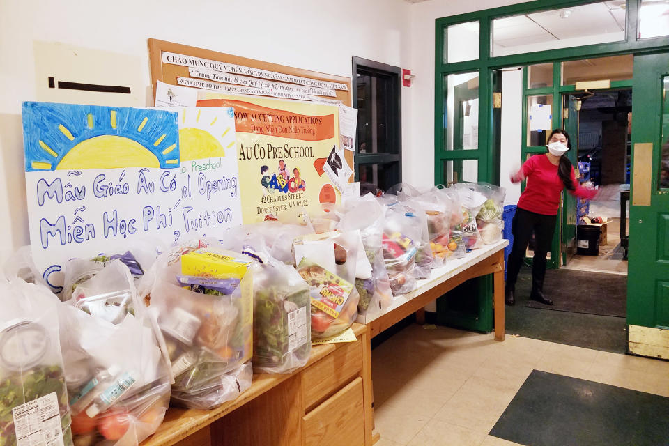 Image: VietAid, a Boston nonprofit, distributes free groceries and meals to the Vietnamese community. (Amy Yee)