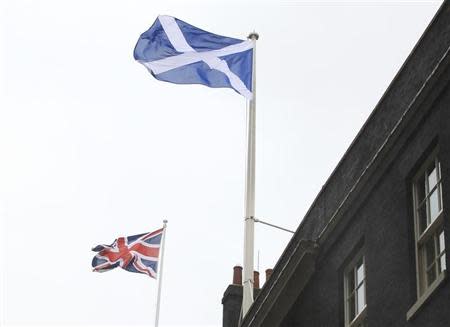 Scotland's nation flag flies alongside the Union flag (L) at Downing Street, in support of Andy Murray's men's final tennis match against Roger Federer of Switzerland, at the Wimbledon tennis championships in London July 8, 2012. REUTERS/Olivia Harris