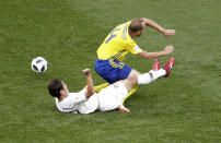 <p>South Korea’s Kim Young-gwongoes to ground with with Sweden’s Andreas Granqvist early on. (AP Photo/Michael Sohn) </p>