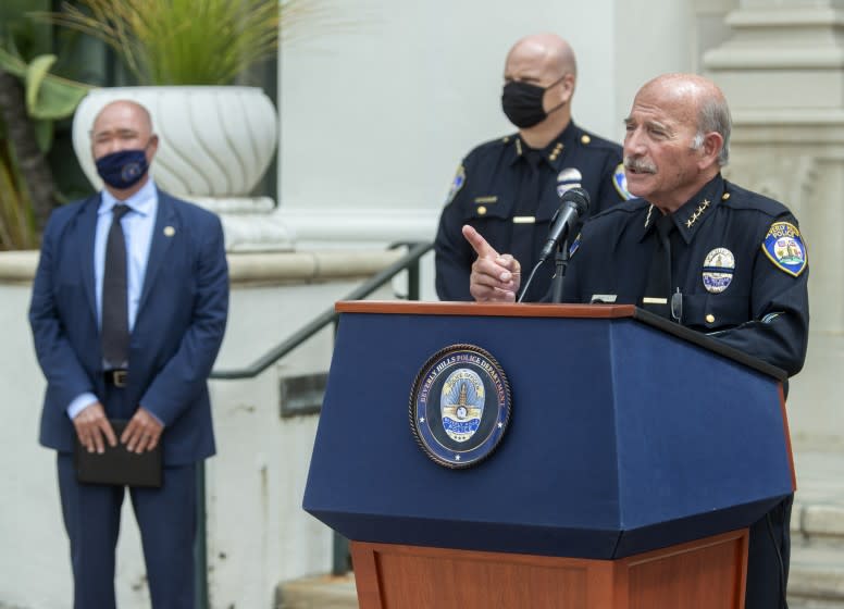 BEVERLY HILLS, CA - MAY 12, 2021: Dominick Rivetti, right, Interim Beverly Hills Police Chief, takes a reporter's question while discussing the arrest of 3 gang members in the armed robbery at a popular Beverly Hills restaurant on March 4, 2021, where a $500,000 watch was stolen. In background left is Matthew Moon, Special Agent in charge of the criminal division, FBI, Los Angeles and in background, center is Marc Coopwood, Beverly Hills Assistant Chief of Police. Press conference was held outside of Beverly Hills City Hall. (Mel Melcon / Los Angeles Times)