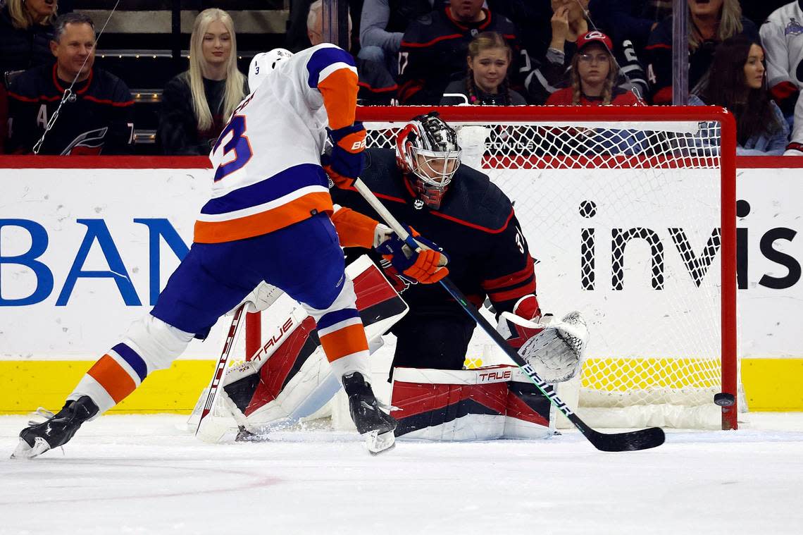 New York Islanders’ Adam Pelech (3) shoots past Carolina Hurricanes goaltender Frederik Andersen, right, during the second period of an NHL hockey game in Raleigh, N.C., Friday, Oct. 28, 2022. (AP Photo/Karl B DeBlaker)