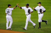 DETROIT, MI - OCTOBER 13: Ramon Santiago #39, Austin Jackson #14, and Don Kelly #32 of the Detroit Tigers celebrate after defeating the Texas Rangers 7-5 in Game Five of the American League Championship Series at Comerica Park on October 13, 2011 in Detroit, Michigan. (Photo by Kevork Djansezian/Getty Images)