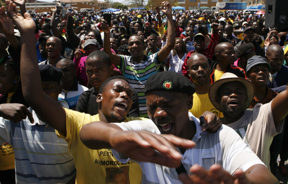 Supporters of a firebrand politician Julius Malema, unseen, sing before he is due to speak after appearing at the Magistrate’s Court in Polokwane, South Africa, Wednesday, Sept. 26, 2012, on charges of money laundering in connection with an improper government tender awarded to a company his family trust partly owns. (AP Photo/Themba Hadebe)