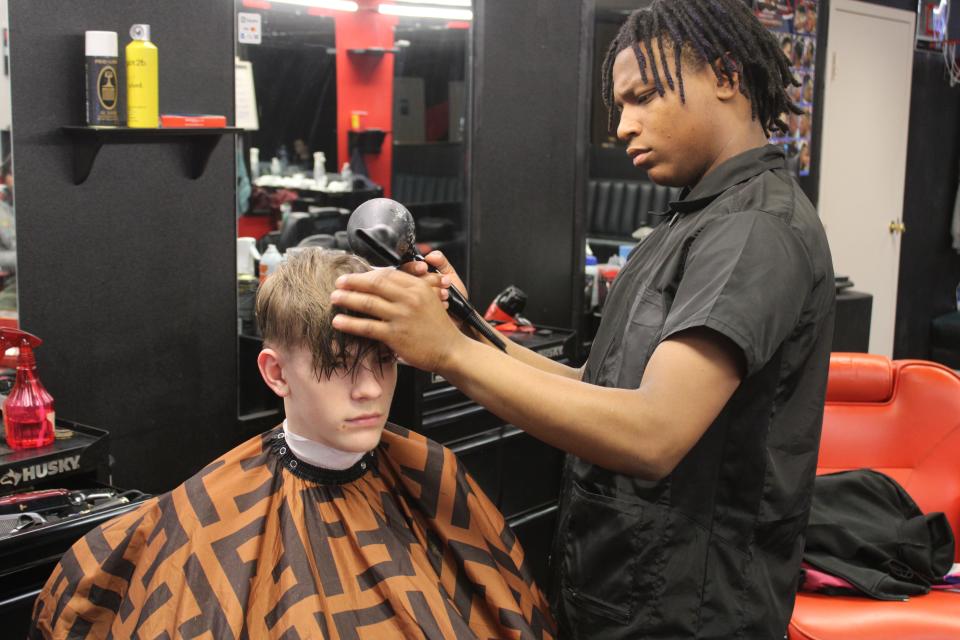 Micaiah Brown, the starting point guard for Stroudsburg boys basketball, shows off his barber talents