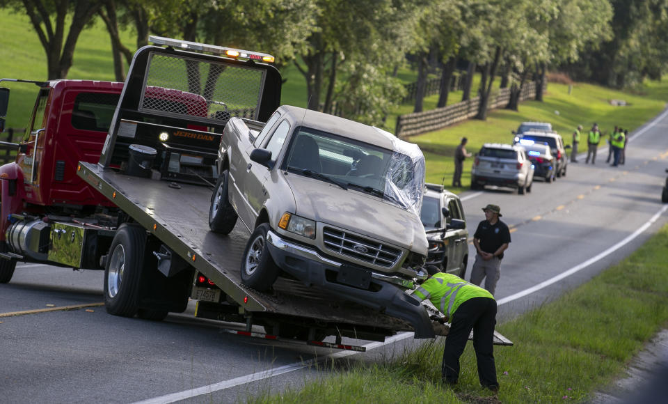 Wreckage is cleared after a bus collied with a small pickup truck killing eight of the more than 50 migrant workers in the bus, Tuesday, May 14, 2024, in Ocala, Fla. The driver of the pick up, Bryan Maclean Howard, was charged with eight counts of DUI manslaughter. (AP Photo/Alan Youngblood)