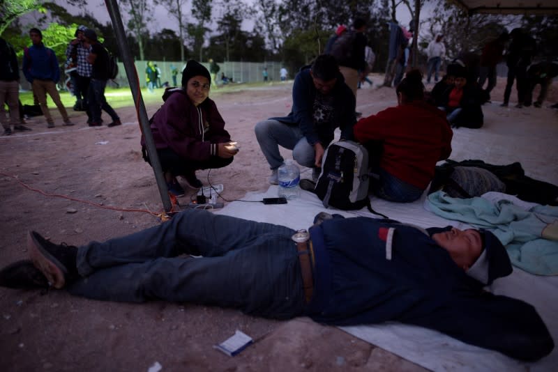 People, part of a caravan of migrants heading toward the United States, rest at the border between Honduras and Guatemala in Agua Caliente