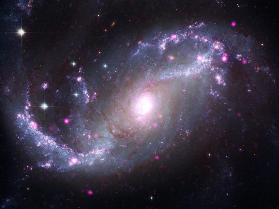 purple galaxy with bright white center with two arms reaching out straight and then spiraling against the blackness of space