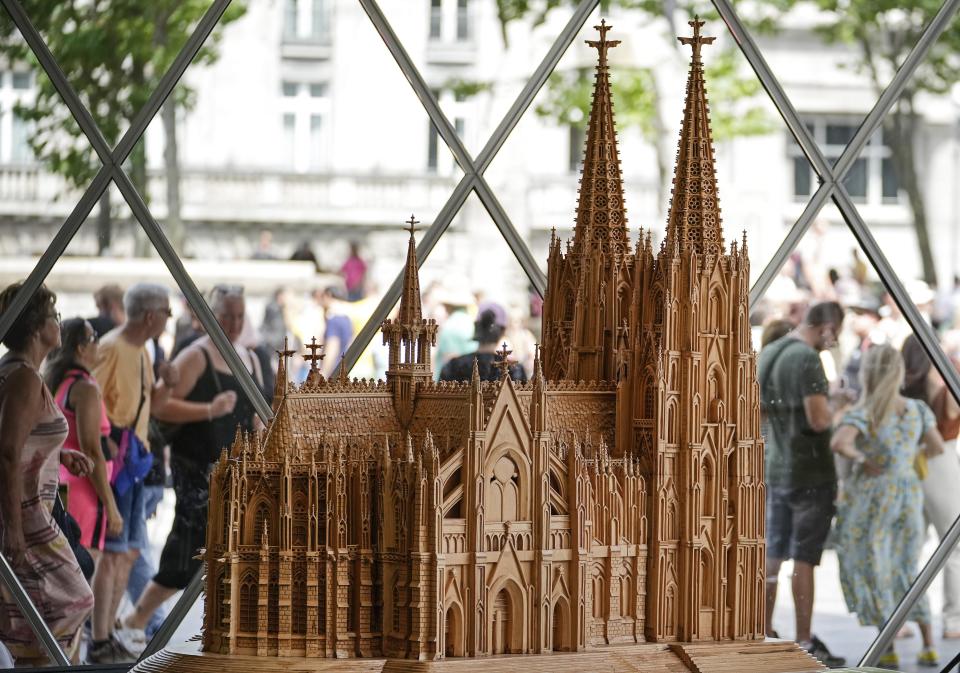 A wooden model of the word heritage Cologne Cathedral, made Fadel Alkhudr from Syria, is displayed at the Domforum in Cologne, Germany, Saturday, June 18, 2022. Fadel Alkhudr, 42, a woodcarver and artist orginally from Aleppo, Syria, fled the war in his home country and arrived in the western german city of Cologne in 2015. In 2019 he started to carve the local Cologne Cathedral in his small basement - without any plans or drawings, using only cell phone photos of the cathedral as a template. (AP Photo/Martin Meissner)