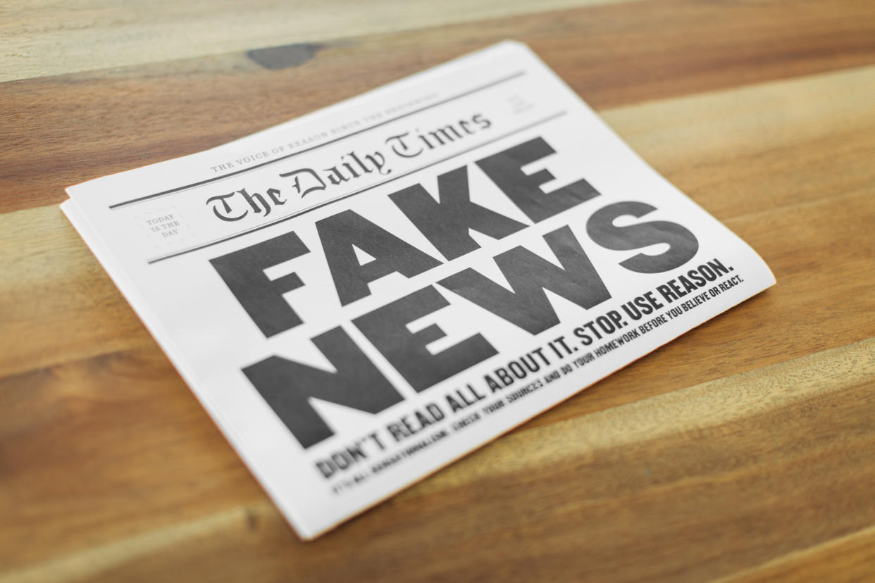 A newspaper publication with the headline Fake News sits folding on a kitchen table. Is the media presenting all the sides of the news story?