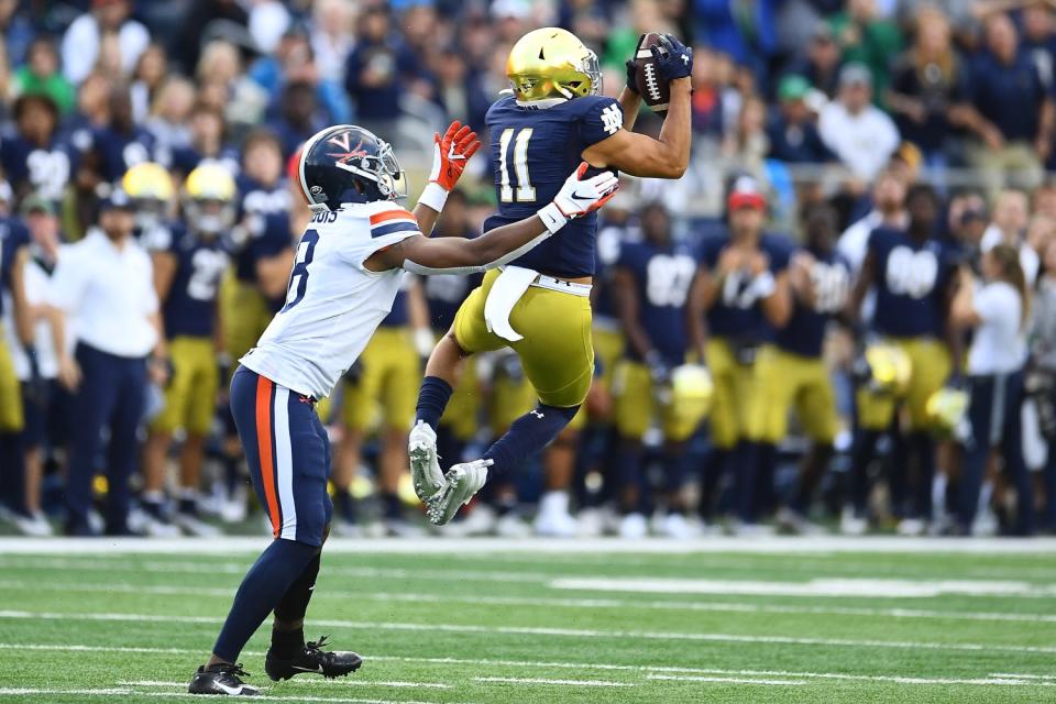 Notre Dame safety Alohi Gilman intercepts a pass intended for Virginia's Hasise Dubois.