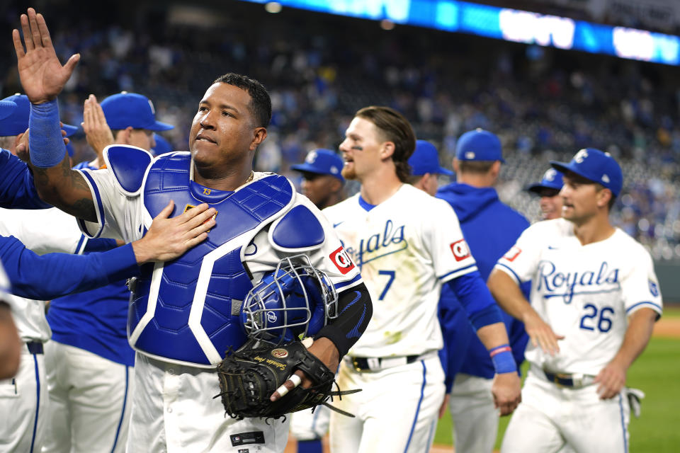 Kansas City Royals' Salvador Perez, left, celebrates with teammates after their baseball game against the Detroit Tigers Tuesday, May 21, 2024, in Kansas City, Mo. The Royals won 10-3. (AP Photo/Charlie Riedel)