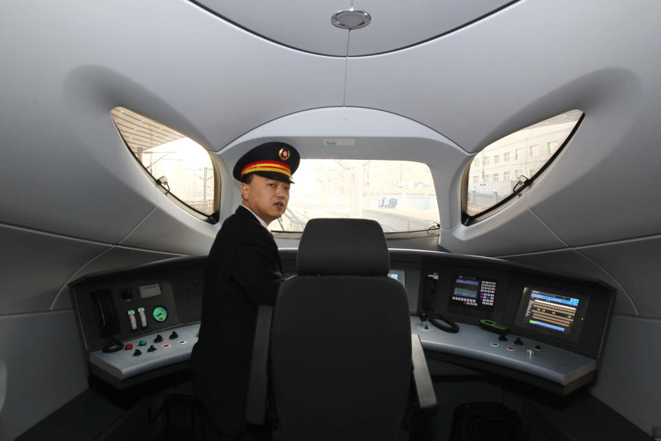 The train driver of the high speed train that runs on the new 2,298-kilometre (1,425-mile) line between Beijing and Guangzhou takes a rest in Zhengzhou train station in Zhengzhou, central China's Henan province on December 26, 2012. China started service on December 26 on the world's longest high-speed rail route, the latest milestone in the country's rapid and -- sometimes troubled -- super fast rail network. The opening of this new line means passengers will be whisked from the capital to the southern commercial hub in just eight hours, compared with the 22 hours previously required. CHINA OUT AFP PHOTO