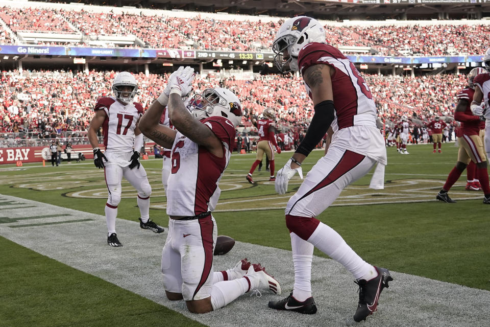 Arizona Cardinals running back James Conner, middle, celebrates with teammates after scoring against the San Francisco 49ers during the second half of an NFL football game in Santa Clara, Calif., Sunday, Nov. 7, 2021. (AP Photo/Tony Avelar)