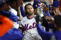New York Mets' Jeff McNeil celebrates in the dugout after scoring against the Pittsburgh Pirates during the sixth inning of a baseball game, Monday, April 15, 2024, in New York. (AP Photo/Noah K. Murray)