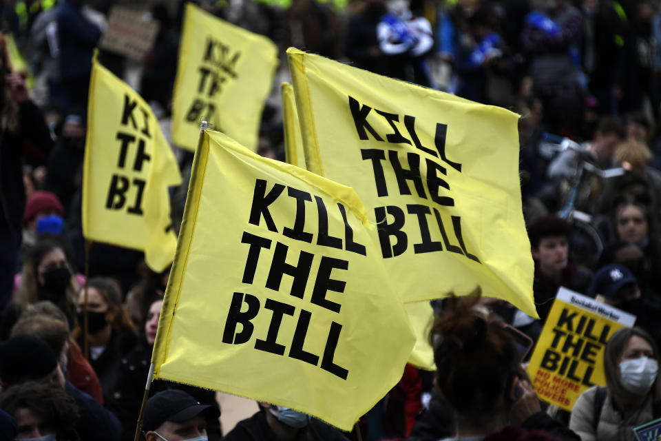 Demonstrators hold flags during a 'Kill the Bill' protest in London, Saturday, April 3, 2021. The demonstration is against the contentious Police, Crime, Sentencing and Courts Bill, which is currently going through Parliament and would give police stronger powers to restrict protests. (AP Photo/Alberto Pezzali)