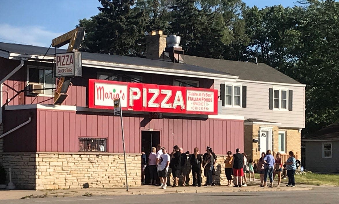 Customers wait in line at Maria's Pizza in 2022, hoping to score a pizza before the founding family closed the southwest side restaurant. New owners will reopen Maria's in 2024 using the same name and recipes.