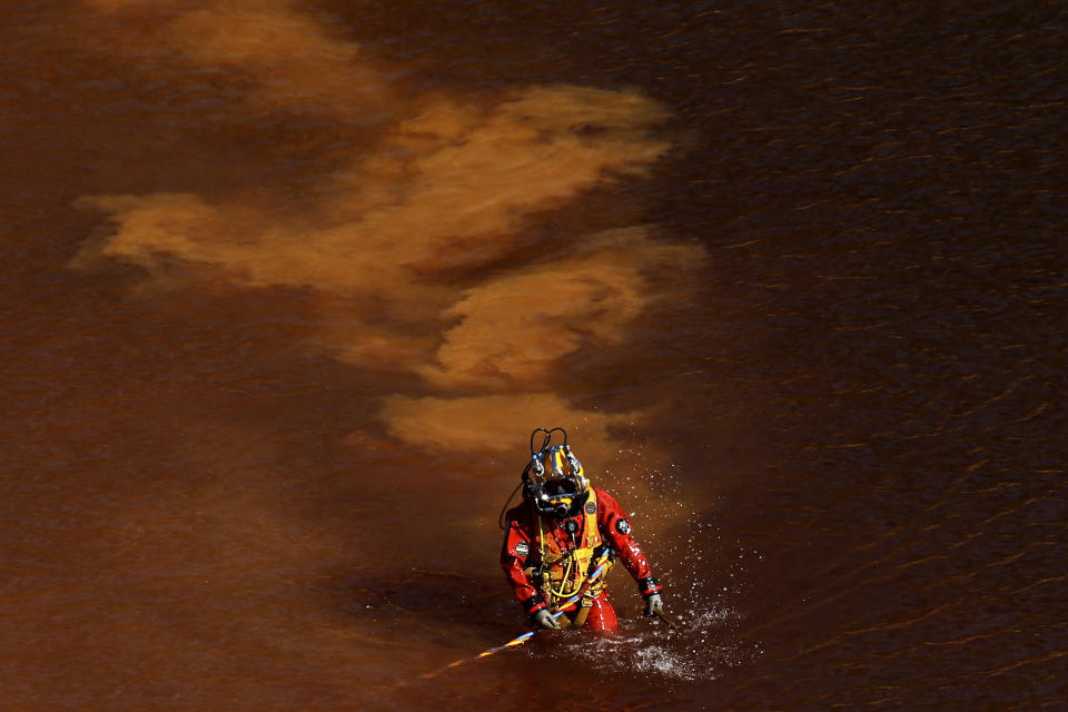 <p>A diver walks out from a toxic man-made lake after a dive search for a third victim near the village of Mitsero outside of the capital Nicosia, Cyprus, Wednesday, May 8, 2019. Investigators hunting for bodies dumped by a suspected serial killer pulled a suitcase containing decomposing human remains from a toxic lake. (AP Photo/Petros Karadjias) </p>