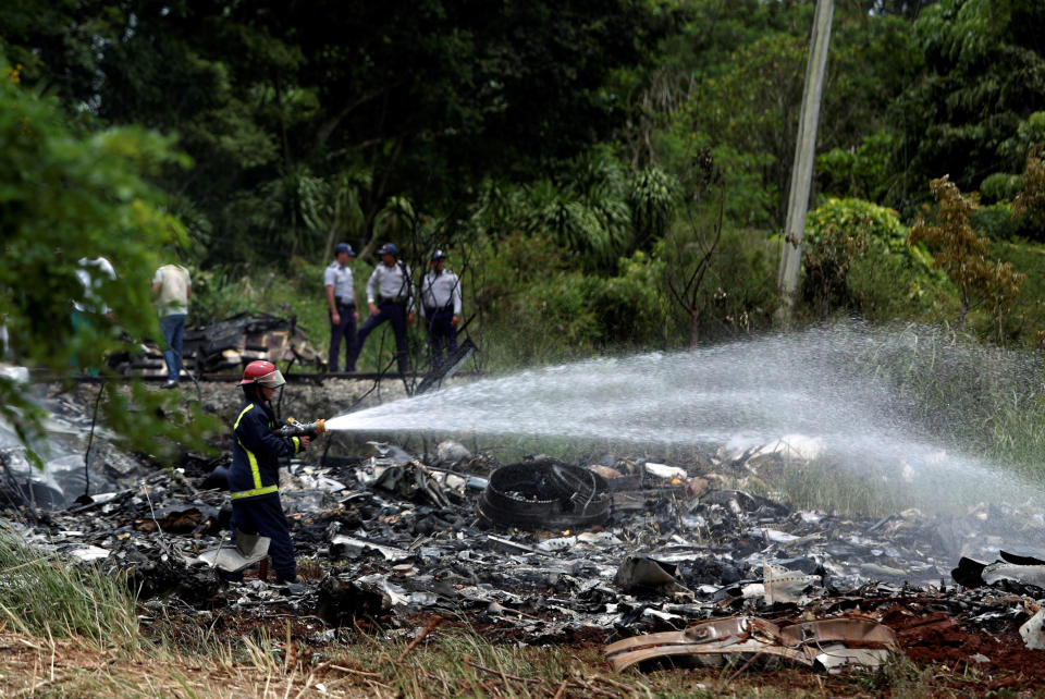 <p>Firefighters work in the wreckage of a Boeing 737 plane that crashed in the agricultural area of Boyeros, around 20 km (12 miles) south of Havana, shortly after taking off from Havana’s main airport in Cuba, May 18, 2018. (Photo: Alexandre Meneghini/Reuters) </p>