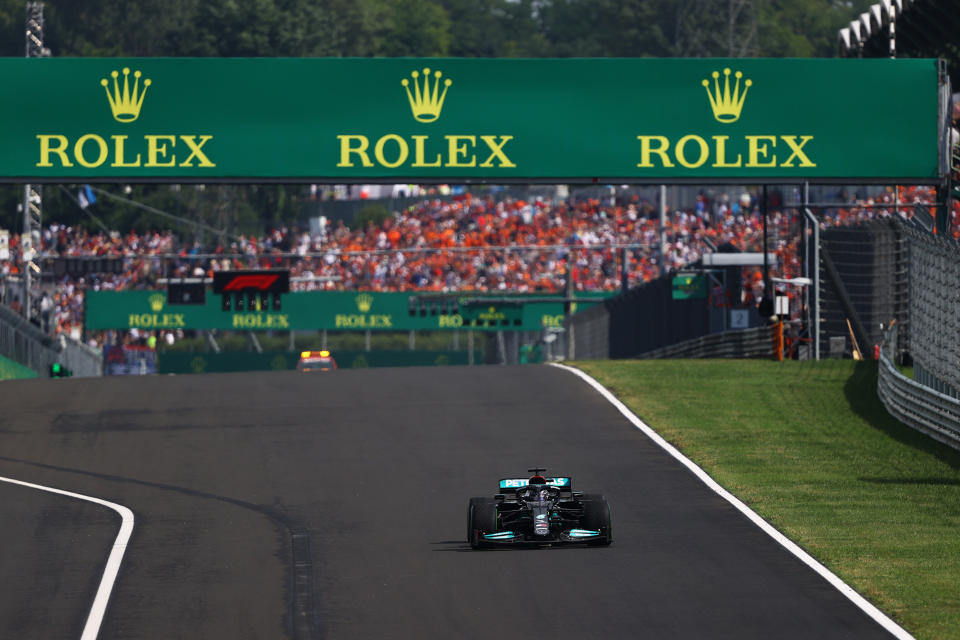 BUDAPEST, HUNGARY - AUGUST 01: Lewis Hamilton of Great Britain driving the (44) Mercedes AMG Petronas F1 Team Mercedes W12 on intermediate tyre into turn one at the restart during the F1 Grand Prix of Hungary at Hungaroring on August 01, 2021 in Budapest, Hungary. (Photo by Bryn Lennon/Getty Images)