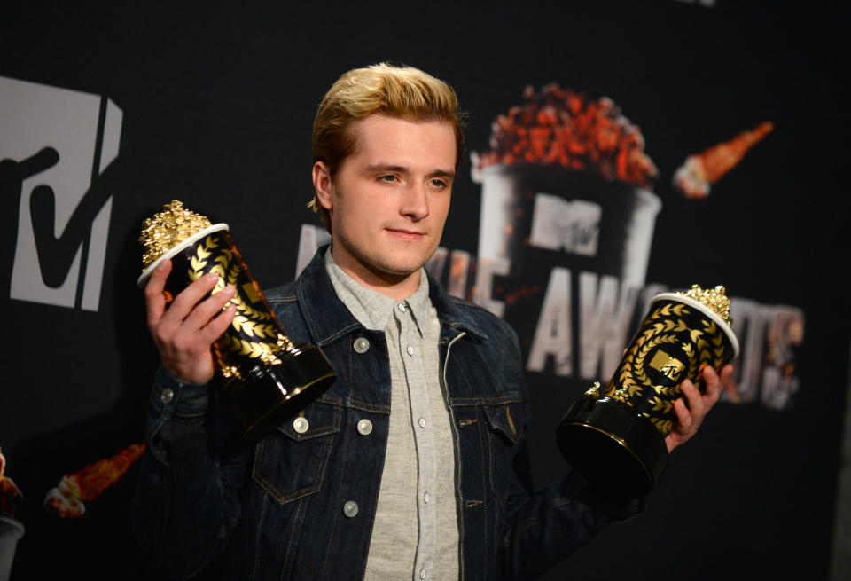 Josh Hutcherson poses with his best male performance award and movie of the year award for "The Hunger Games: Catching Fire" in the press room at the MTV Movie Awards on Sunday, April 13, 2014, at Nokia Theatre in Los Angeles. (Photo by Jordan Strauss/Invision/AP)