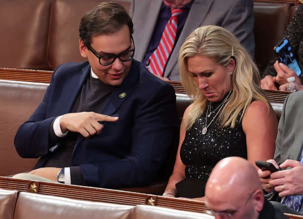 PHOTO: U.S. Rep.-elect George Santos, R-N.Y.,talks to Rep.-elect Marjorie Taylor Greene, R-Ga., in the House Chamber during the third day of elections for Speaker of the House at the Capitol on Jan. 5, 2023, in Washington, D.C. (Win McNamee/Getty Images, FILE)