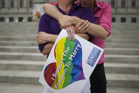 Mike Woods, 28, and Brandon Parsons, 30, embrace on the Pennsylvania State Capital steps following a rally with gay rights supporters after a ruling struck down a ban on same sex marriage in Harrisburg, Pennsylvania, May 20, 2014. REUTERS/Mark Makela