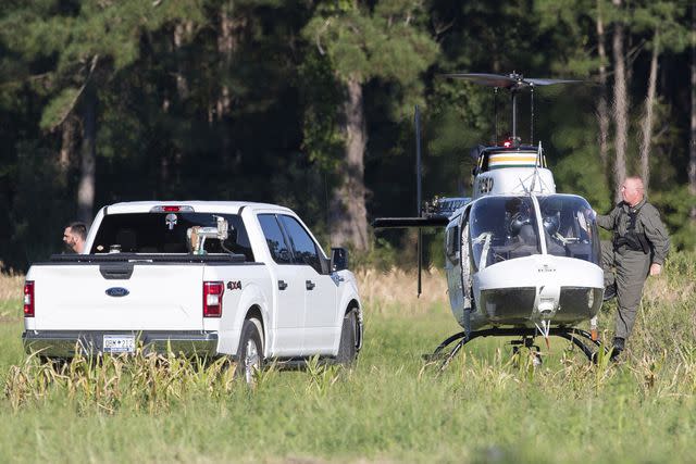 <p>Henry Taylor/The Post And Courier via AP</p> Pilots exit a Florence County Sheriff's Office helicopter after locating the position of a stealth fighter jet that crash-landed the previous day in a nearby field in Williamsburg County, S.C., on Monday, Sept. 18, 2023.