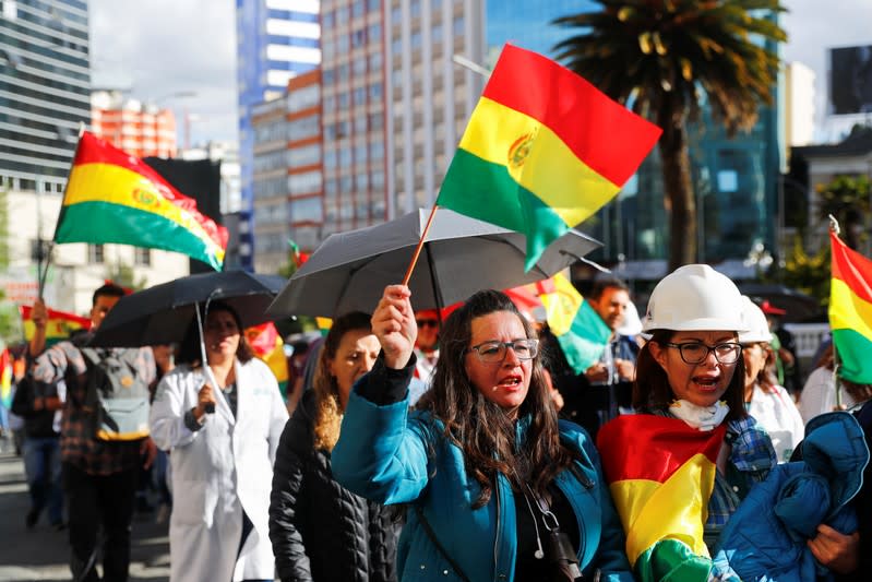Opponents of Bolivia's President Evo Morales wave Bolivian flags during a protest, in La Paz