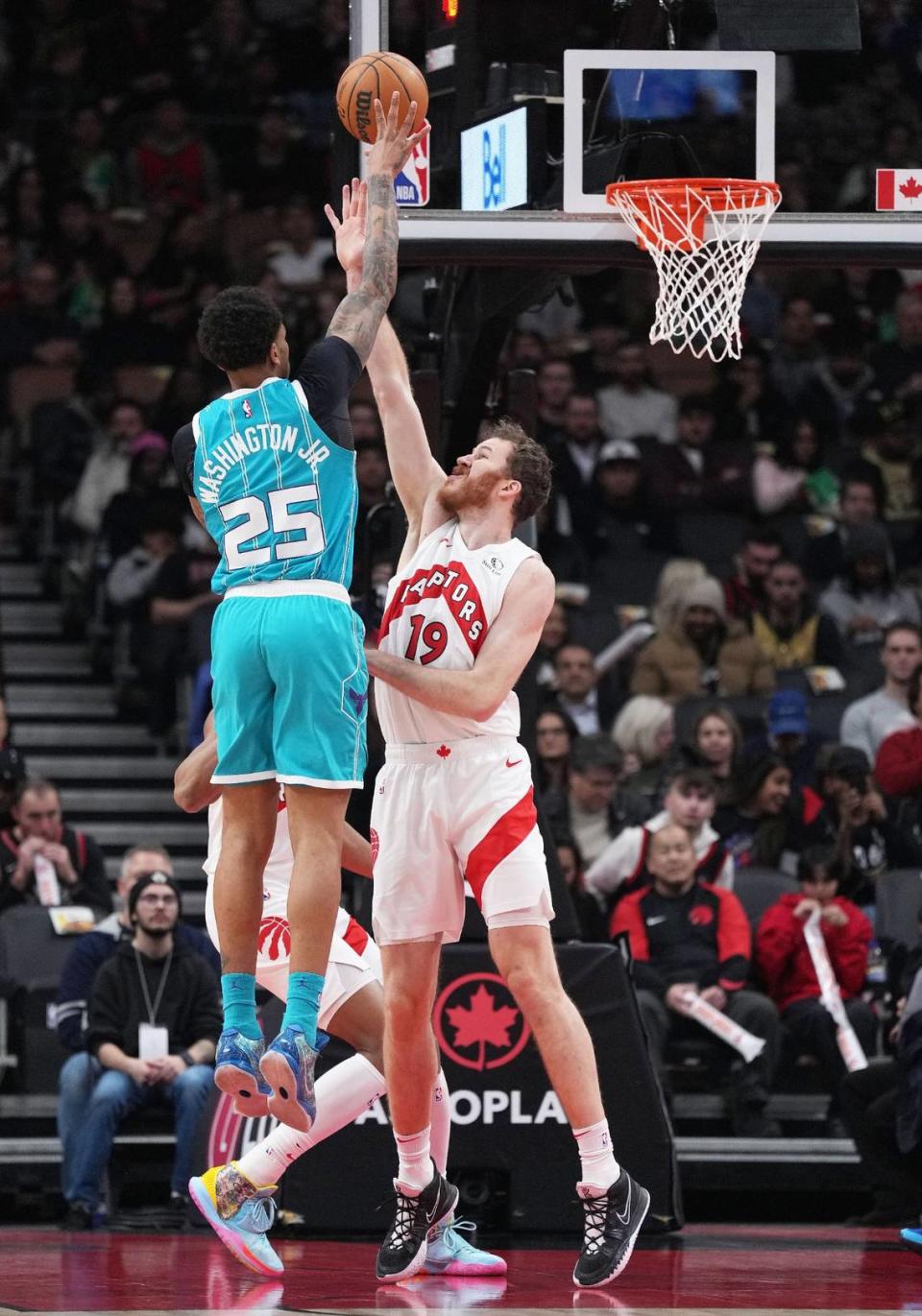 Charlotte Hornets forward P.J. Washington (25) shoots the ball at the basket as Toronto Raptors center Jakob Poeltl (19) tries to defend during the first quarter at Scotiabank Arena. Nick Turchiaro/USA TODAY NETWORK