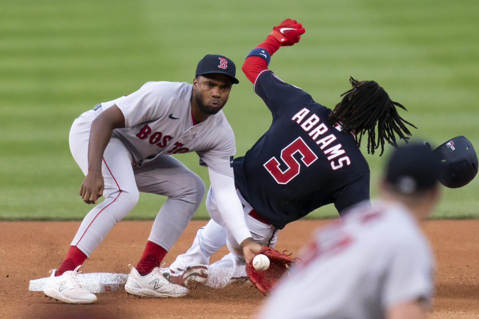 Washington Nationals' CJ Abrams, right, steals second base next to Boston Red Sox second baseman Pablo Reyes during the first inning of a baseball game Tuesday, Aug. 15, 2023, in Washington. (AP Photo/Stephanie Scarbrough)