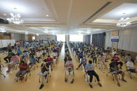 Students wait to be sure of no side effects after receiving the Pfizer-BioNTech COVID-19 vaccine at a hospital in Bangkok, Thailand, Tuesday, Sept. 21, 2021. Bangkok Metropolitan Administration inoculated 12-18 year old students on Tuesday as part of its attempt to reopen on-site schools. (AP Photo/Sakchai Lalit)