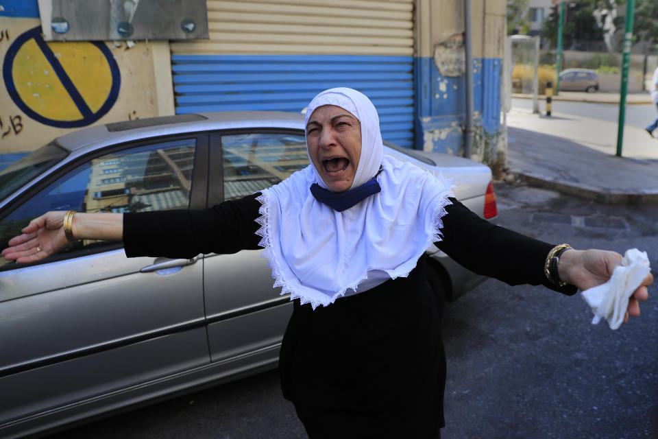 The aunt of Ibrahim Harb, 35, a Lebanese man who was critically injured in the massive explosion at Beirut's port last year and who died on Monday evening nearly 14 months after the blast, mourns during his funeral procession, in Beirut, Lebanon, Tuesday, Sept. 28, 2021. On August 4, 2020, hundreds of tons of ammonium nitrate, a highly explosive material used in fertilizers, ignited after a massive fire at the port. The death brings to at least 215 the number of people who have been killed by the blast, according to official records. (AP Photo/Hussein Malla)