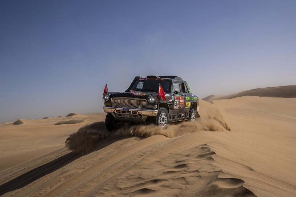 In this Monday, Jan. 13, 2020 photo, driver Quan Ruan, of China, and co-driver Yirong Wang, of China, race their Chevrolet during stage eight of the Dakar Rally in Wadi Al Dawasir, Saudi Arabia. Formerly known as the Paris-Dakar Rally, the race was created by Thierry Sabine after he got lost in the Libyan desert in 1977. Until 2008, the rallies raced across Africa, but threats in Mauritania led organizers to cancel that year's event and move it to South America. It has now shifted to Saudi Arabia. The race started on Jan. 5 with 560 drivers and co-drivers, some on motorbikes, others in cars or in trucks. Only 41 are taking part in the Original category. (AP Photo/Bernat Armangue)