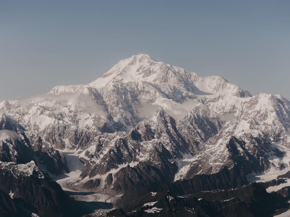 A view of Denali — a huge mountain with snow-capped peaks — from plane in Alaska