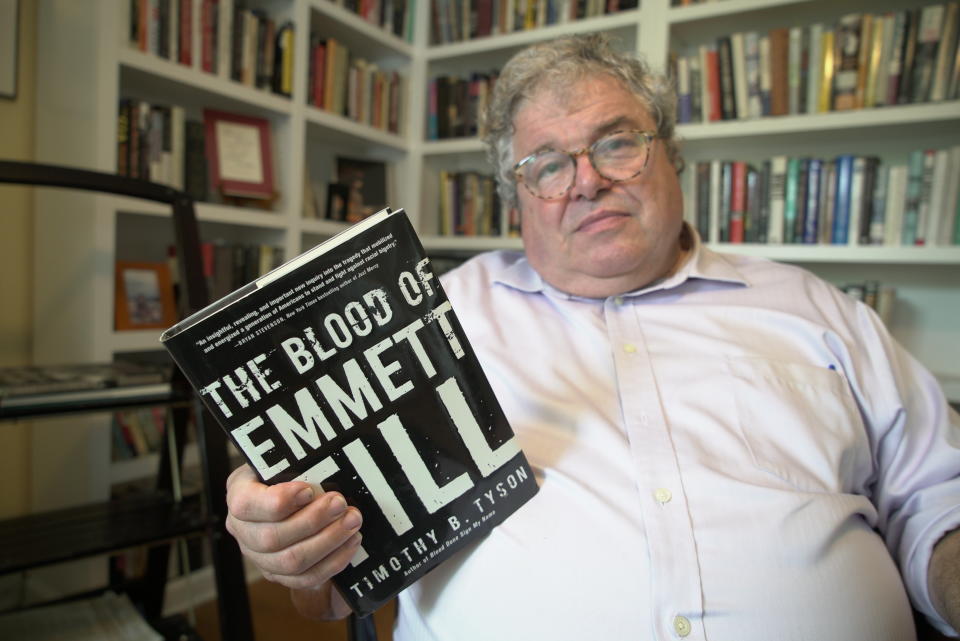 Author Timothy Tyson holds a copy of his book on the Emmett Till lynching case at his home in Durham, N.C., on Thursday, July 14, 2022. (AP Photo/Allen G. Breed)