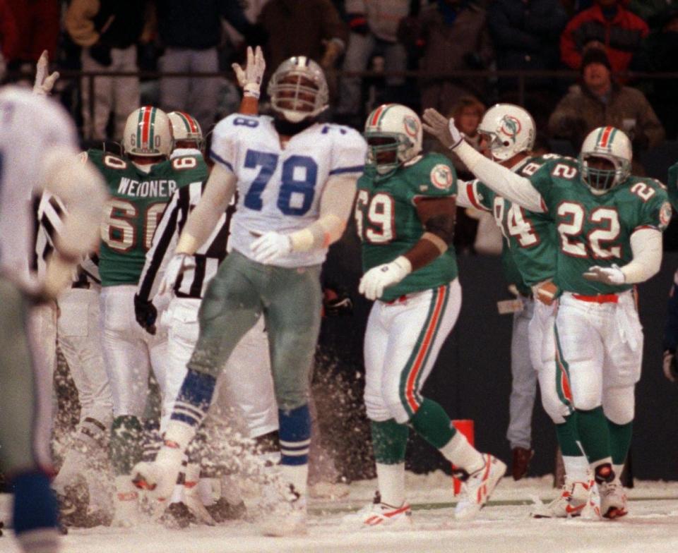 Leon Lett of the Dallas Cowboys kicks the snow as he realizes his gaffe on Thanksgiving Day 1993 was going to give the Dolphins a second chance at a last-play winning field goal, which turned into a 16-14 Miami win. Dolphins in the background Bert Weidner (60), Keith Sims (69), Greg Baty (84) and James Saxon (22), signal their delight.