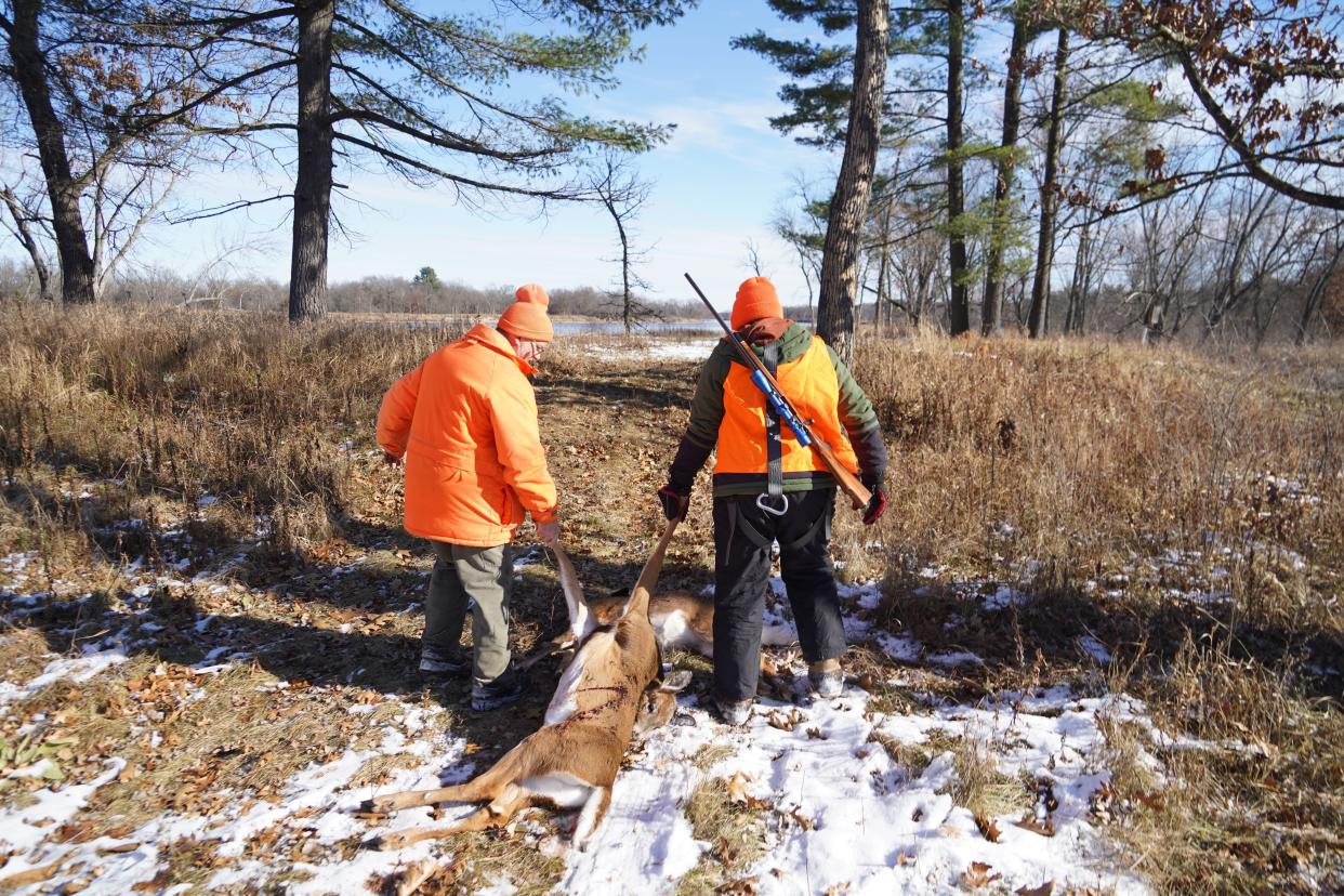 Steve Swenson, left, and his son Soren drag a deer during a hunt Sunday in Sauk County.