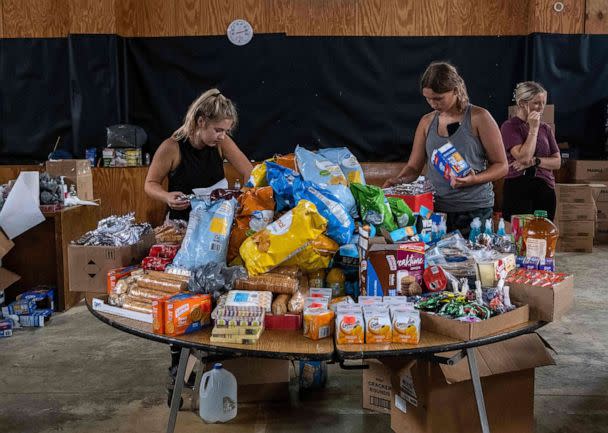 PHOTO: Volunteers work at a distribution center of donated goods in Buckhorn, Ky., following historic flooding in Eastern Kentucky, July 31, 2022. (Seth Herald/AFP via Getty Images)