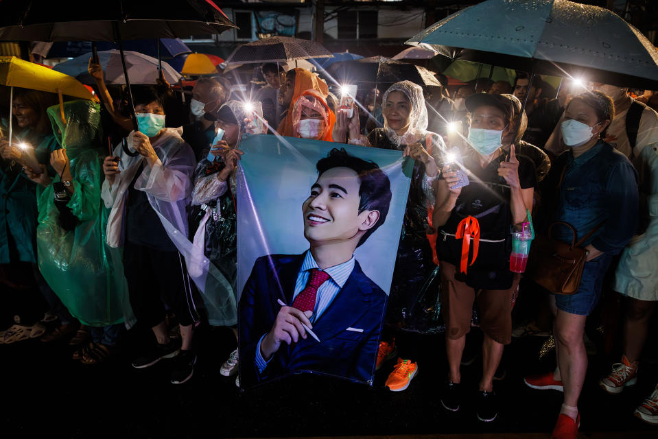 Protesters hold up the three-finger salute and a portrait of Pita Limjaroenrat, leader of the Move Forward Party, during a protest in Bangkok on July 23, 2023. <span class="copyright">Andre Malerba—Bloomberg/Getty Images</span>