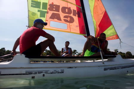 Civil Engineering student Anette Perez, 23, (C) sails in a rented sailboat during her vacations at the beach in Varadero, Cuba, August 26, 2015. REUTERS/Alexandre Meneghini