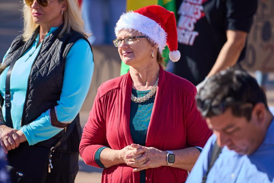 While wearing a festive hat, Arizona State Sen. Kelly Townsend listens to speeches at Wesley Bolin Memorial Plaza in Phoenix on Friday, Nov 25, 2022.
(Photo: Alex Gould/The Republic)