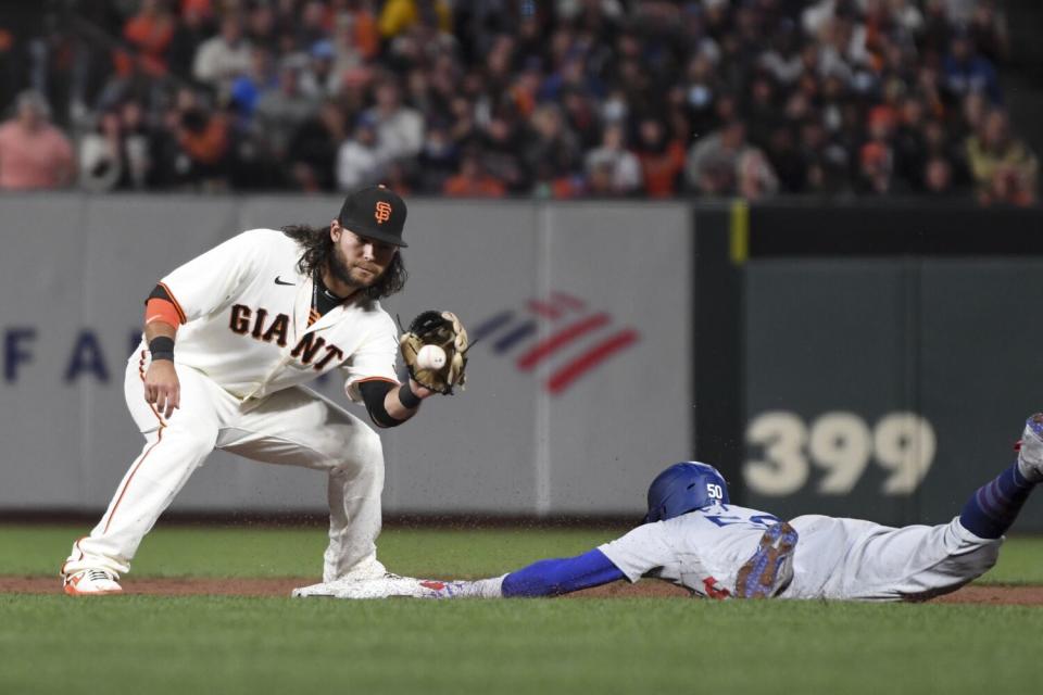 Dodgers' Mookie Betts, right, steals second base ahead of the tag of Giants' Brandon Crawford on Oct. 14, 2021.