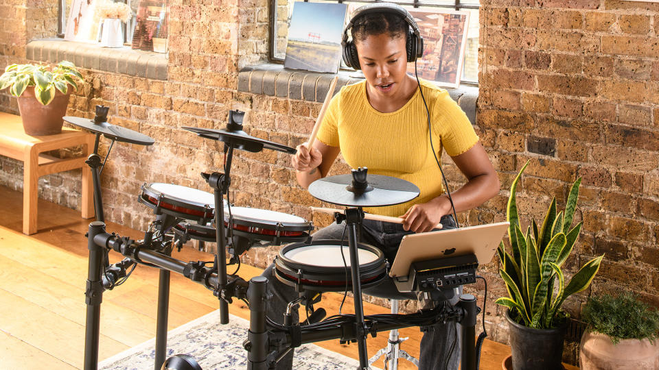 Woman playing Alesis Nitro Max e-kit